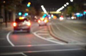 View of a blurry road through a car windshield